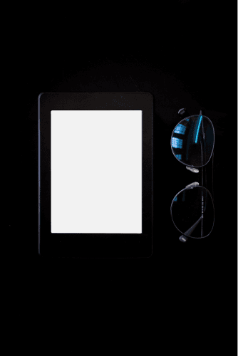 Kindle Mockup With Black Background And Glasses