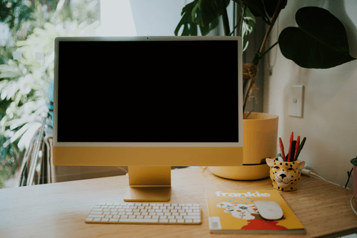 Imac Mockup Resting On A Wooden Table