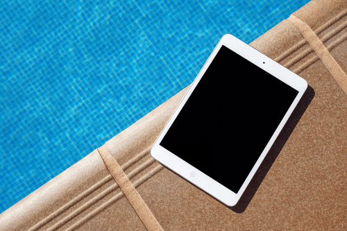 Ipad Mini Mockup Next To A Pool