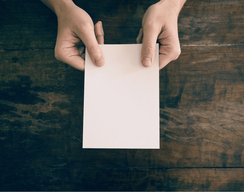 Women Holding Postcard Mockup On Wooden Table