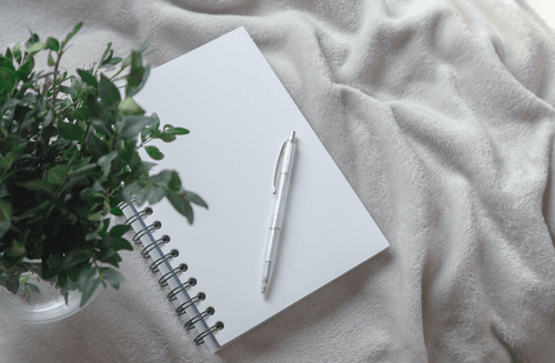 Spiral Notebook Mockup On Bed